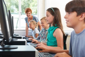 Teacher observing Children at computers